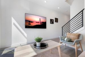 a living room with a table and a chair at Cheerful 3-BDR Th NR UW Seattle Childrens w Free P in Seattle