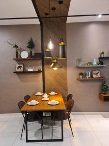 a dining room with a wooden table and chairs at The Roberstson family suite with city views in Kuala Lumpur
