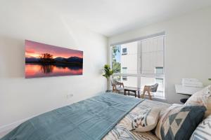 a bedroom with a bed and a large window at Cheerful 3-BDR Th NR UW Seattle Childrens w Free P in Seattle