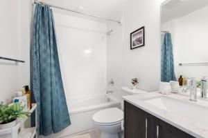 a bathroom with a toilet and a sink and a tub at Cheerful 3-BDR Th NR UW Seattle Childrens w Free P in Seattle +22 photos