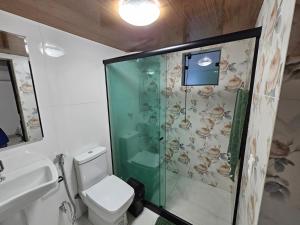 a bathroom with a shower and a toilet and a sink at Rio Sereno Suítes Comfort - Lumiar in Lumiar +73 photos