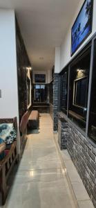 a living room with a tv on a brick wall at Casa De Nazareth Homestay in Cochin