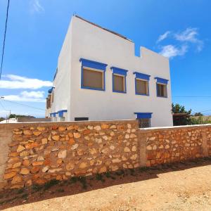 a white house behind a stone wall at tamazirt surf in Agadir