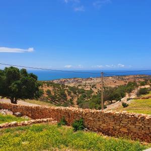 a stone wall with the ocean in the background at tamazirt surf in Agadir +3 photos