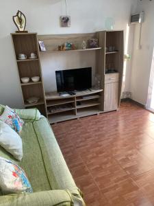 a living room with a couch and a flat screen tv at studio maryphil in Saint-Martin