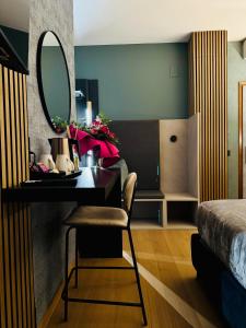 a bedroom with a desk with a mirror and a bed at Villa Riviera Hotel Udine in Pradamano