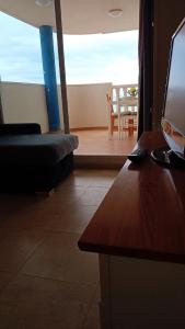 a living room with a couch and a table with a television at vistas panoranicas al mar desde su terraza in Moncófar +10 photos