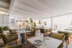 a dining room with tables and chairs in a restaurant at Corte Patitari - by Patitari Suites in Gallipoli