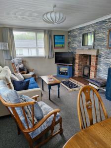 a living room with a couch and a fireplace at 2 bedroom chalet bungalow on Humberston Fitties. in Humberston