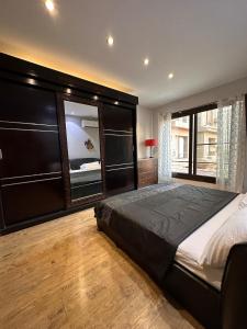 a bedroom with a large bed and a large window at Villa Rose in Sheikh Zayed +48 photos