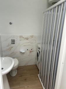 a bathroom with a white toilet and a sink at Home Sweet Home in Guarrato +12 photos