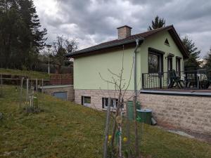 a small house with a porch and a balcony at Ferienhaus Am Freibad in Bad Berka