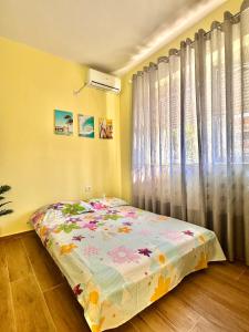 a bedroom with a bed in front of a window at Vlora Vibe in Vlorë