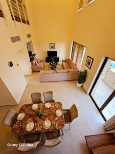 a living room with a table and a couch at C32 Samarah Resort LOFT apartment in Sowayma