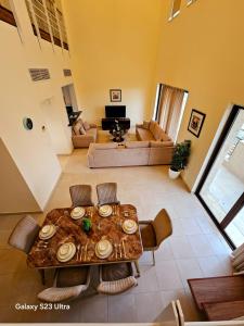a living room with a table and a couch at C32 Samarah Resort LOFT apartment in Sowayma +21 photos