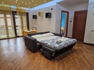 a large bed in a room with wooden floors at Moonlight Apartment in Fiumicino