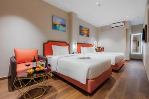 Postel nebo postele na pokoji v ubytování Salute Saigon Hotel and Spa