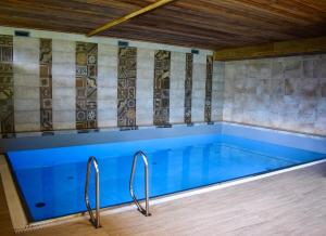 a large swimming pool with blue water in a room at Gosau Apartment 202 in Gosau