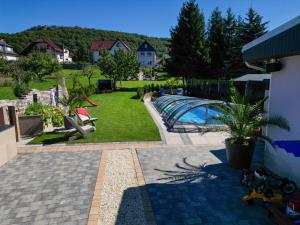 a view of a backyard with a swimming pool at Pension Zur Krone in Martinfeld