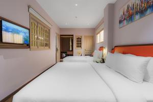 Postel nebo postele na pokoji v ubytování Salute Saigon Hotel and Spa + 37 fotografií
