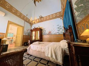 a bedroom with a bed and a painting on the wall at Palazzo Framarino dei Malatesta - Noble Floor - XIV Century in Giovinazzo +175 photos