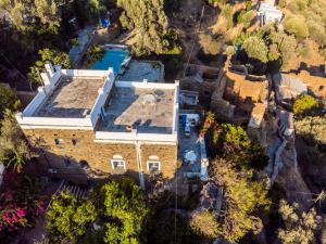 an aerial view of a house with a swimming pool at Anezas Mansion stone-built traditional villa in Andros