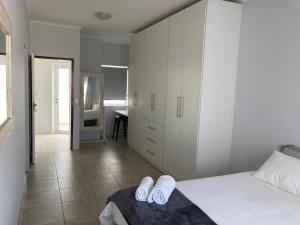a bedroom with a bed with white slippers on it at Self Catering Private Suite in Walvis Bay