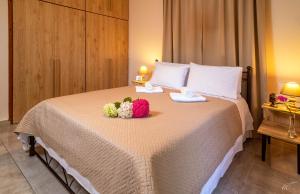 a hotel room with a bed with flowers on it at Fotini's House Tsagarada Pelion in Tsagarada