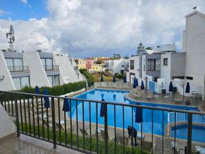 a view of a swimming pool from a balcony at Penelope Beach Hotel Apts in Protaras