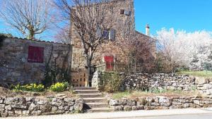 an old stone building with a stone wall and stairs at Charmant studio, maison en pierre, terrace and garden in Veyras