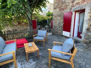 a group of chairs and a table and a table and chairs at Charmant studio, maison en pierre, terrace and garden in Veyras +6 photos