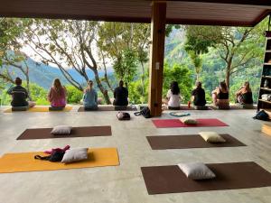 a group of people sitting in a room doing yoga at GAIA ELLA Ecolodge and Yoga Centre in Ella