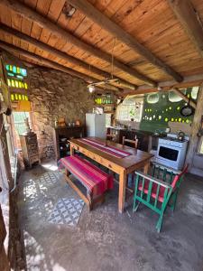 a kitchen with a wooden table and chairs in a room at Gentil Morada in Villa Yacanto