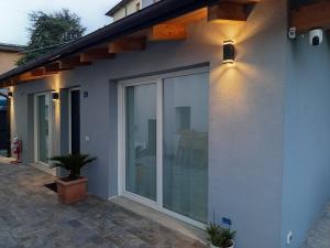 a house with sliding glass doors on the side of it at Iris Cottage in Anzola dell'Emilia