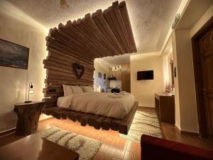 a bedroom with a large bed with a large wooden headboard at 4 MOUNTAIN HILLS in Megalo Chorio