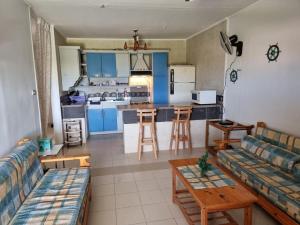 a living room with a couch and a kitchen at Ballah Chalet- North Coast- Egypt in Dawwār ‘Abd Allāh