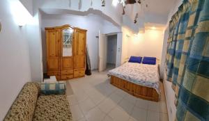 a bedroom with two beds and a wooden cabinet at Ballah Chalet- North Coast- Egypt in Dawwār ‘Abd Allāh