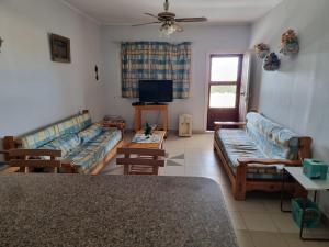 a living room with two couches and a tv at Ballah Chalet- North Coast- Egypt in Dawwār ‘Abd Allāh