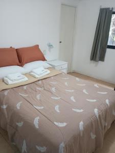 a bedroom with a bed with white feathers on it at Flor de Espinillo Estancia Grande in Estancia Grande +17 photos