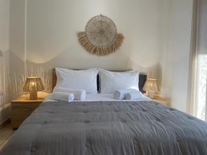 a bedroom with a large bed with towels on it at Konstantino's Apartment in Monemvasia