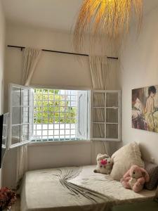 a bedroom with two stuffed animals sitting on a bed at Corniche la Marsa in Douar el Hafey