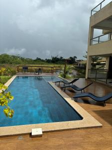 a swimming pool next to a building at villa privilege ap 01 in Marau