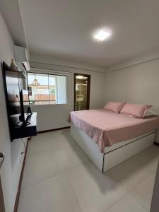 a bedroom with a bed and a television in it at villa privilege ap 01 in Marau +11 photos