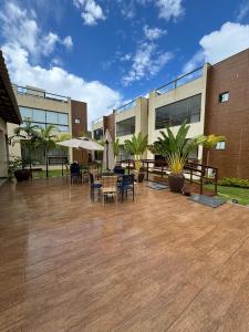a patio with chairs and tables in front of a building at villa privilege ap 01 in Marau
