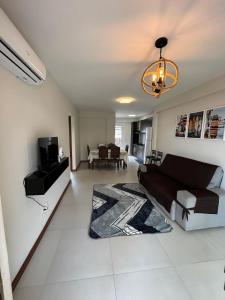 a living room with a couch and a tv in it at villa privilege ap 01 in Marau