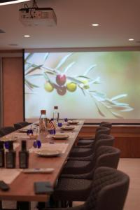 a large conference room with a long table and chairs at Villa EVA Resort & Boutique in Dobrovo