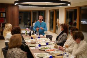 a man standing at a table with a group of people at Villa EVA Resort & Boutique in Dobrovo