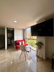 a living room with a red couch and a table at Nice View to Relax In Poblado in El Poblado