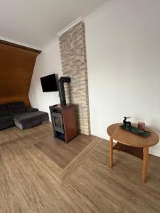 a living room with a wood stove and a couch at Unser Harztraum in Blankenburg