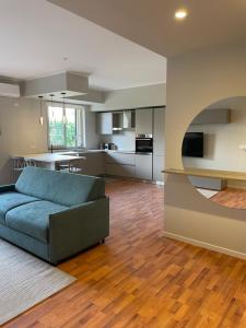 a living room with a couch and a kitchen at Magellano Home in San Gregorio di Catania